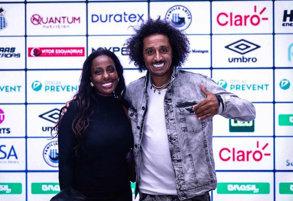 Participantes posam diante do painel de patrocinadores da SCP 2026, com o logotipo Umbro visível ao fundo. Registro de exposição da marca no Congresso Técnico.